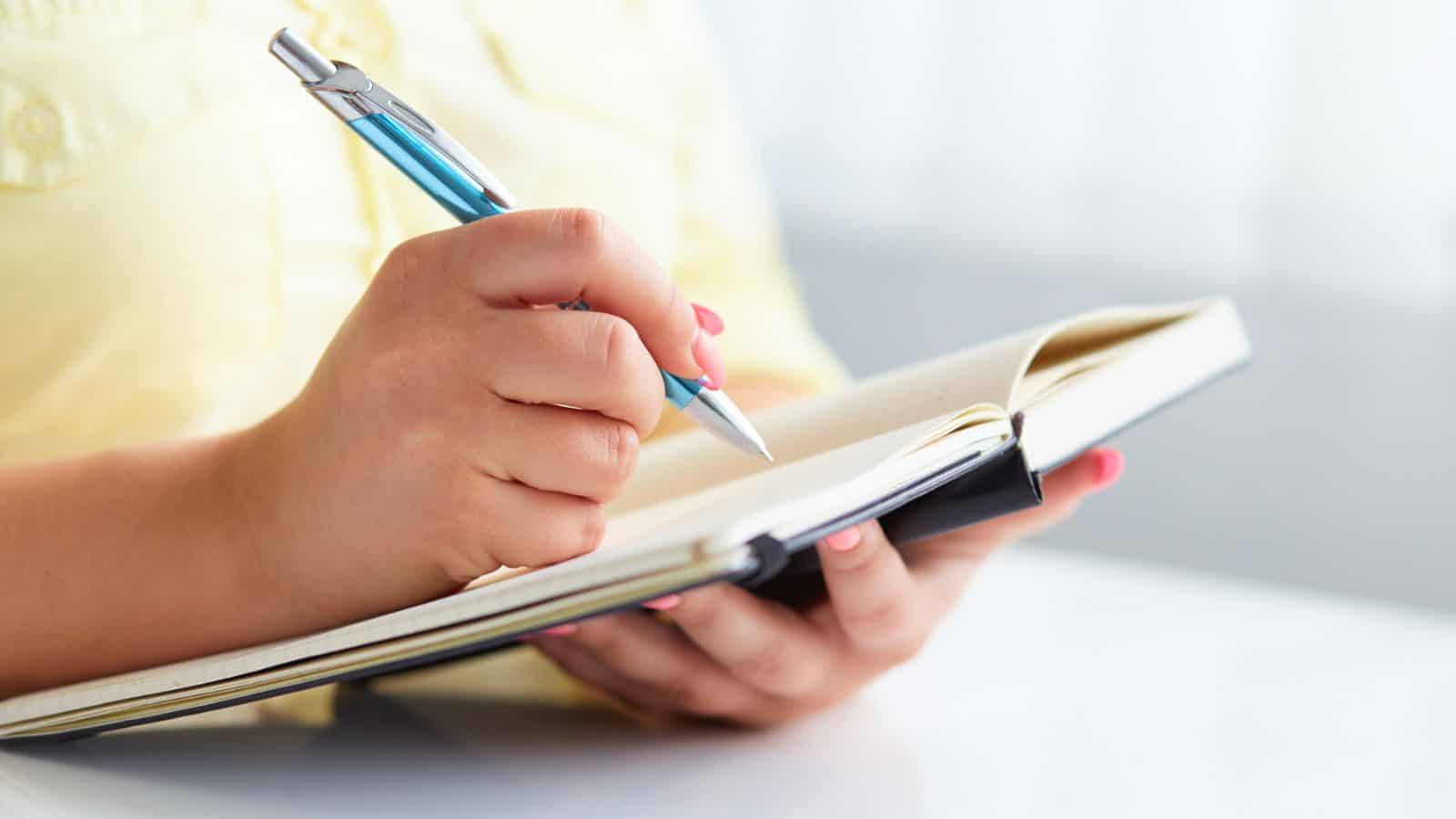 woman writing in a journal