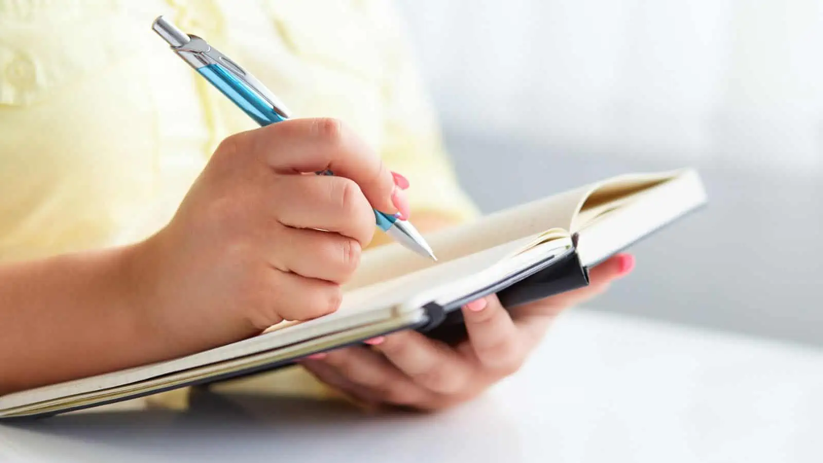 woman writing in a journal