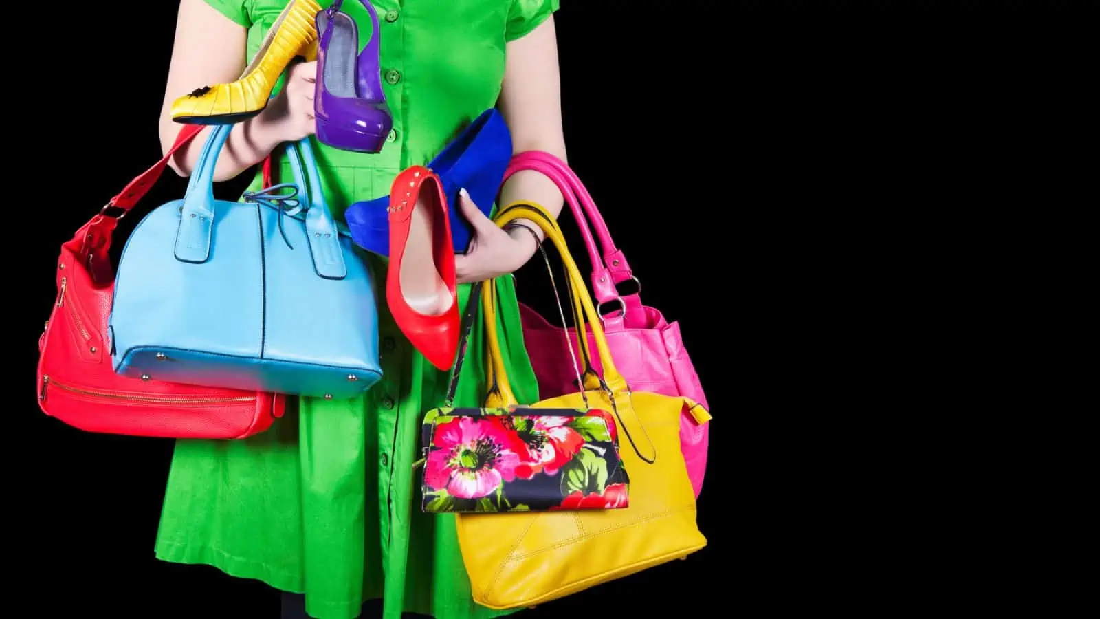 woman holding a bunch of different colored purses and shoes