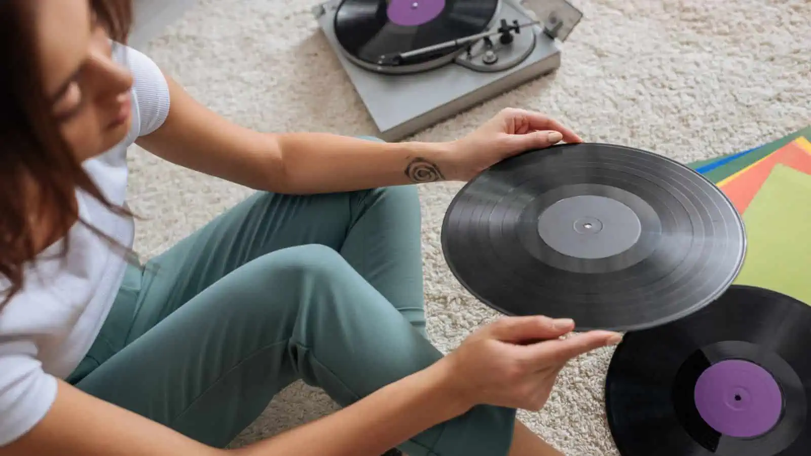 woman holding vinyl records