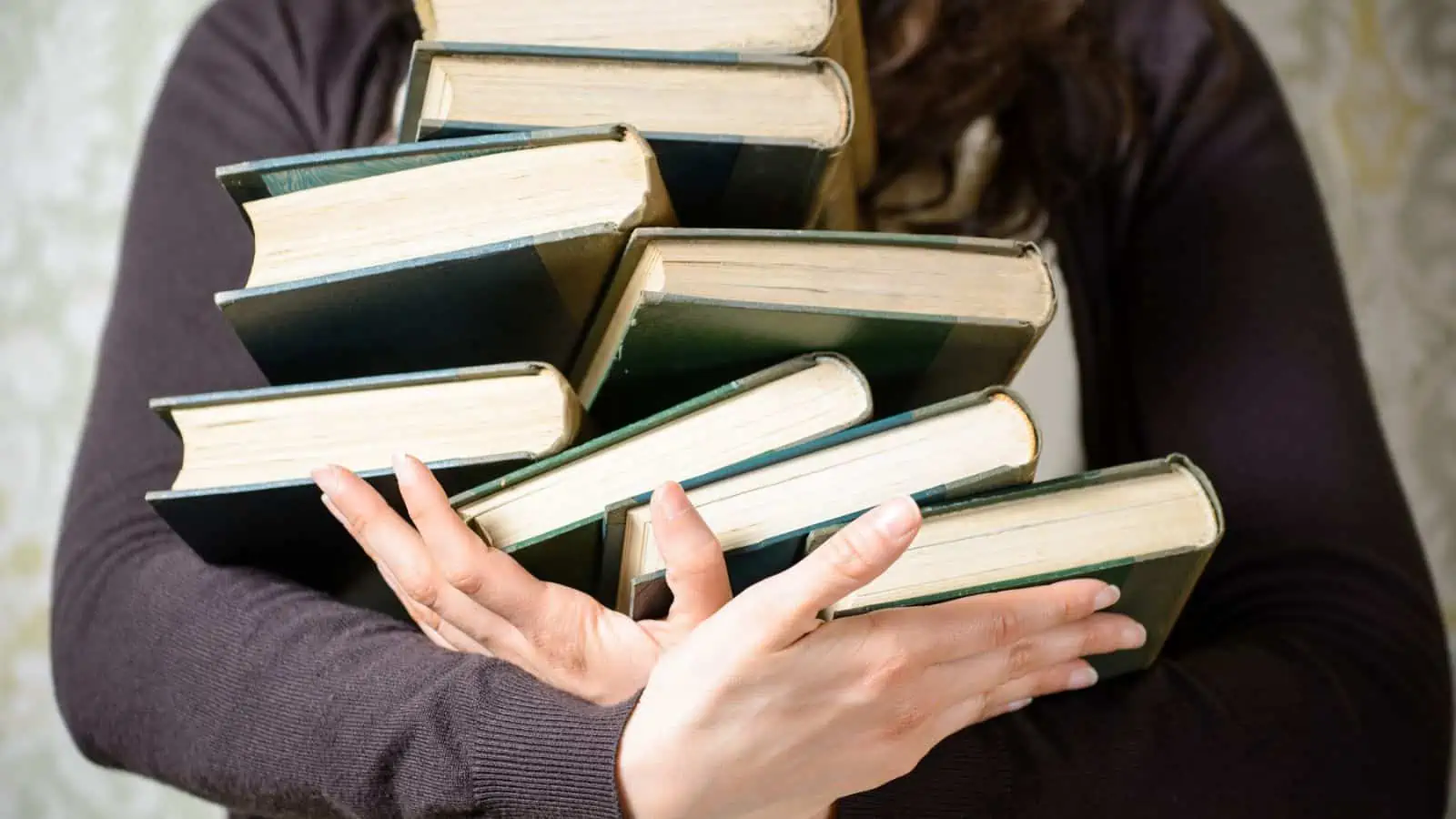 woman with arms full of books