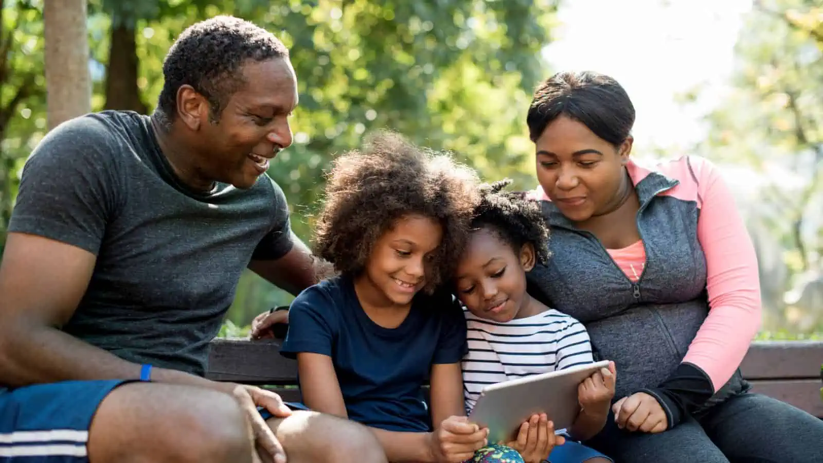 family on tablet ourside