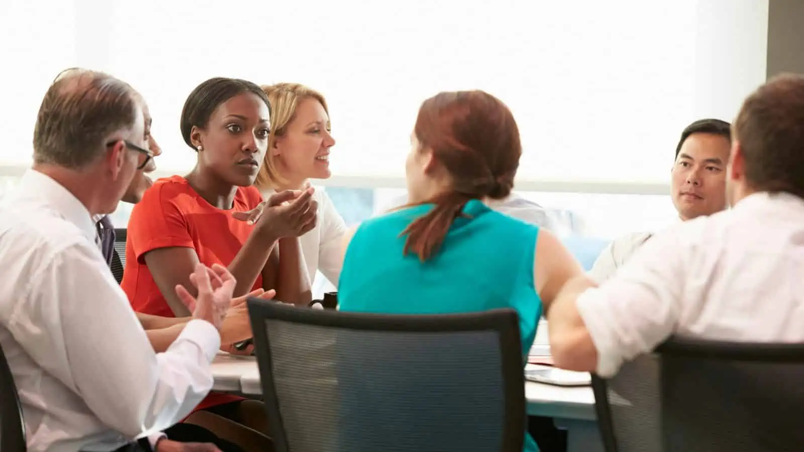 group of professional people sitting around table