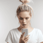 shocked woman looking at phone