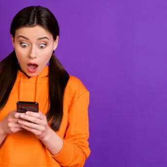 shocked woman looking at phone