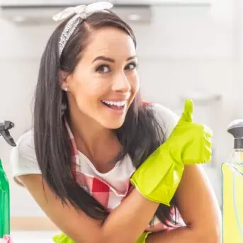 smiling woman wearing cleaning gloves