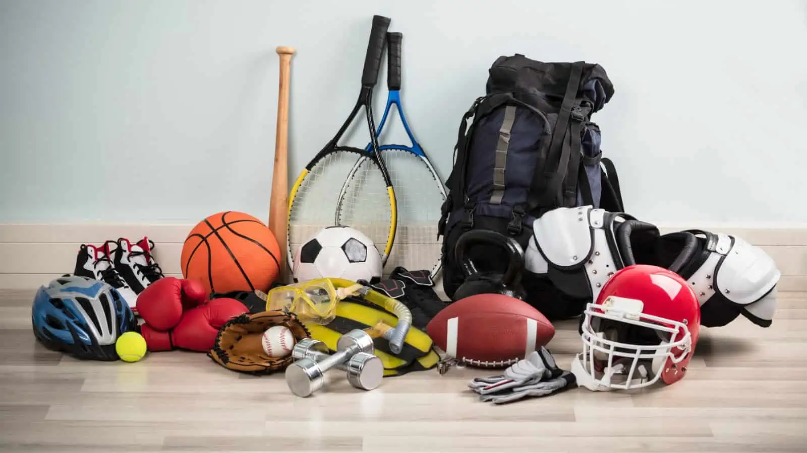 sport gear basketball football soccerball helmets and tennis racket