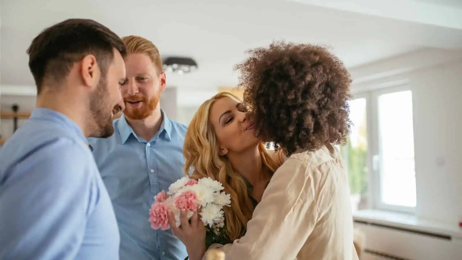 two men and two women greeting one another