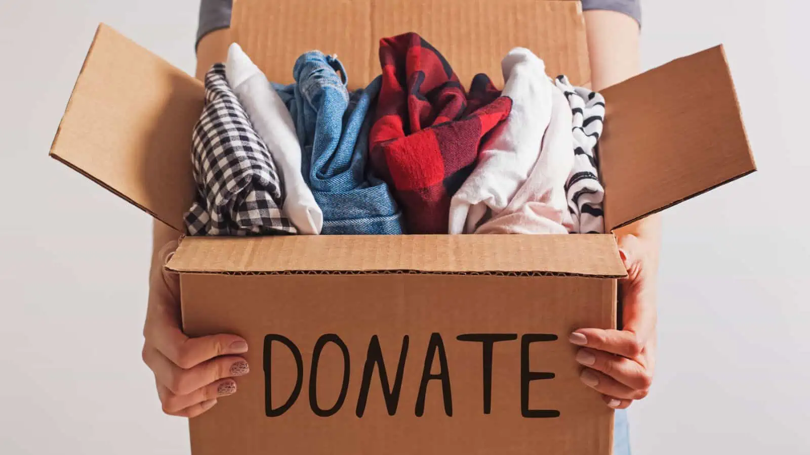 woman holding box of donations