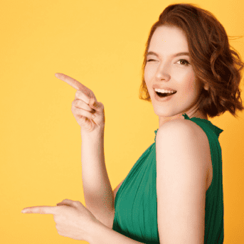 woman in green dress winking and pointing