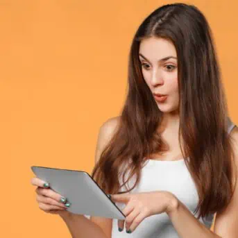 woman on tablet orange background