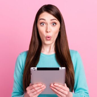 woman on tablet pink background