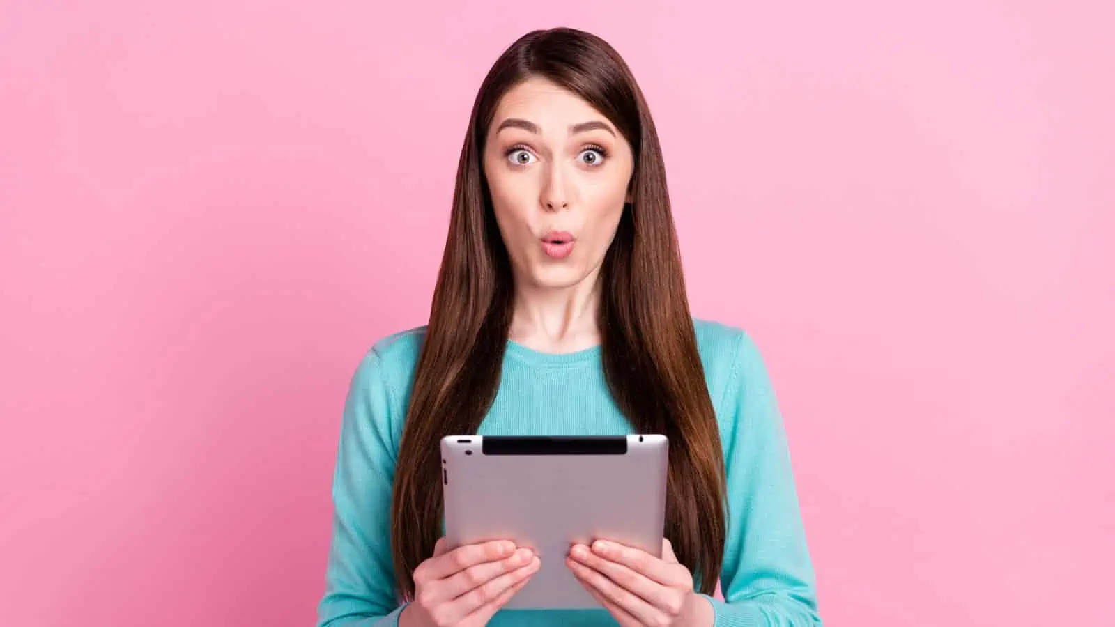 woman on tablet pink background