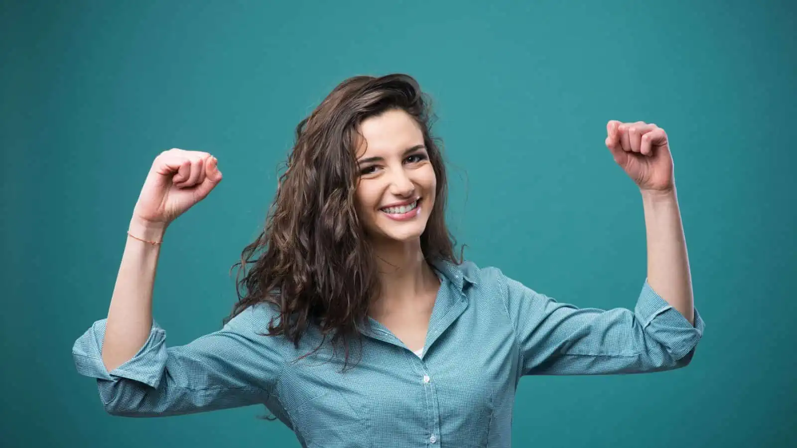 woman smiling and holding arms up