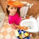 Woman cleaning toilet