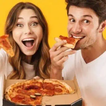 happy couple eating pizza