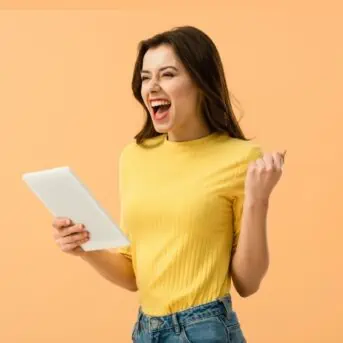 excited woman holding a tablet