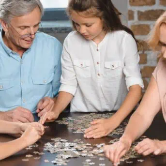 grandparents making puzzle with grandkids
