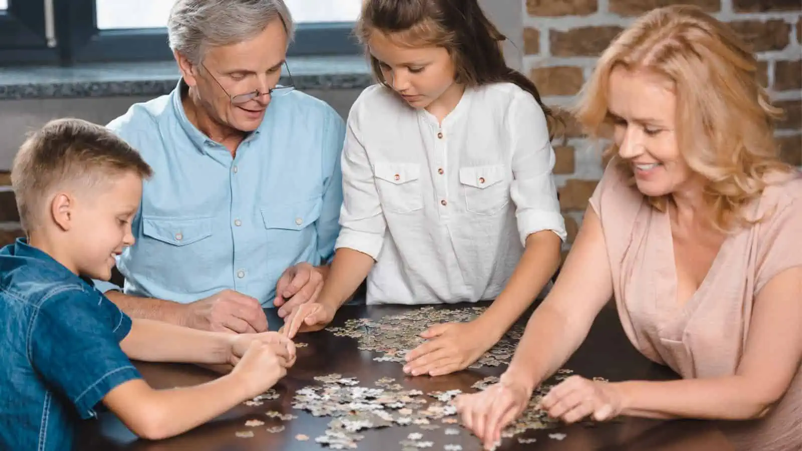 grandparents making puzzle with grandkids