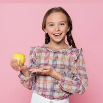 smiling girl holding an apple