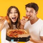 happy couple eating pizza