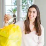 happy woman throwing cup away