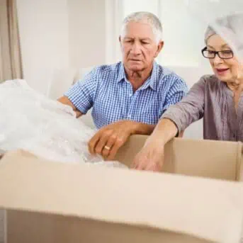 older couple packing moving box