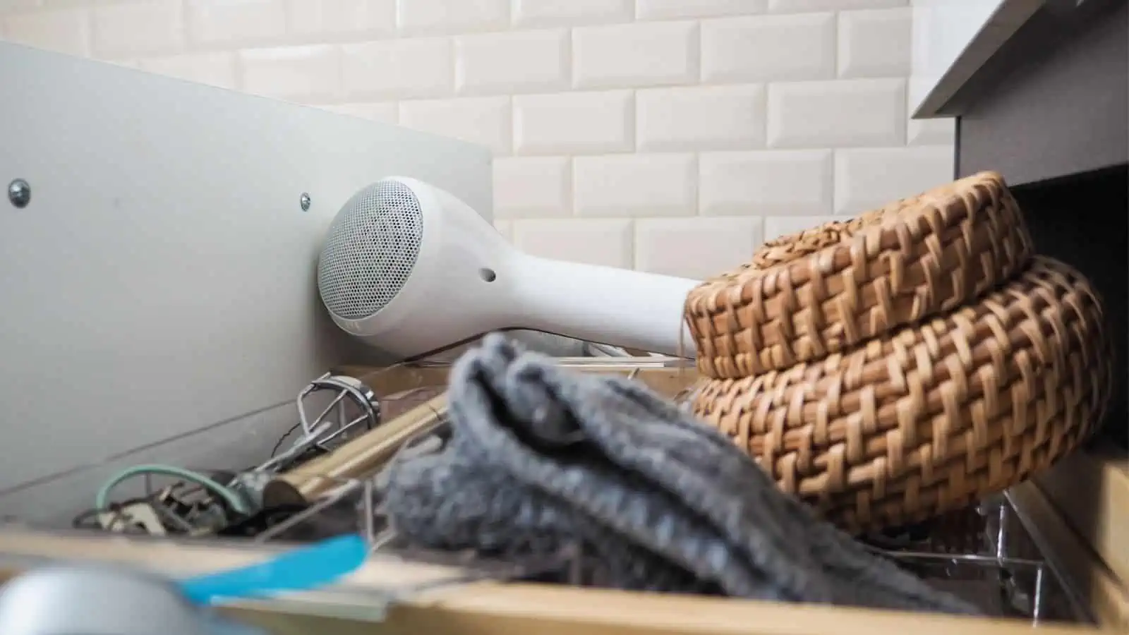 overflowing bathroom drawer with hair dryer