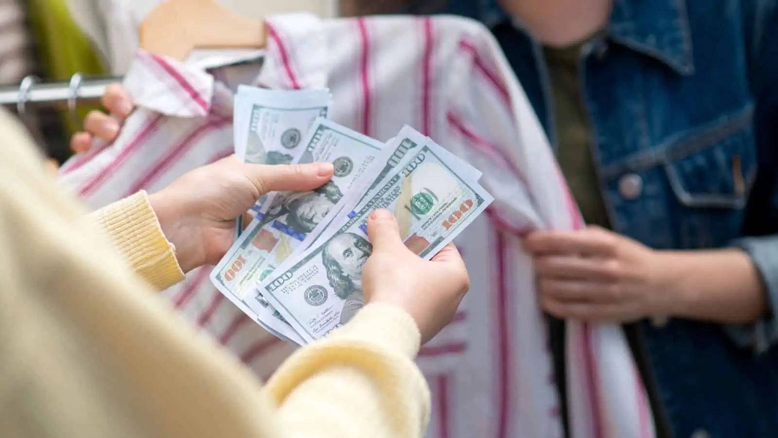 people exchanging money at a garage sale