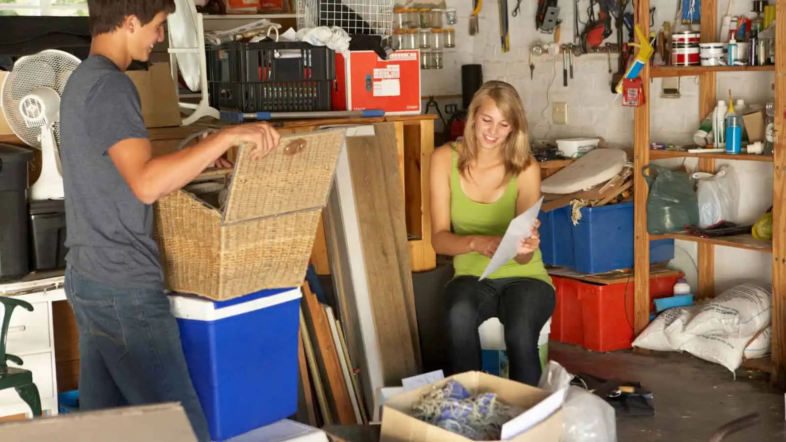 people in a garage with a lot of stuff