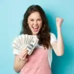 smiling woman holding money