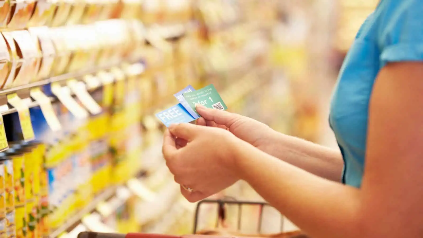 woman holding coupons in grocery store