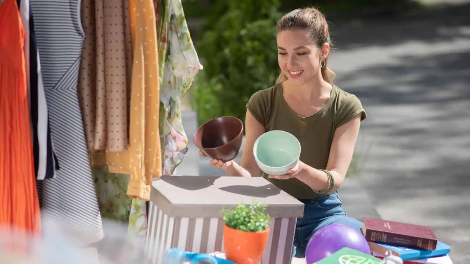 woman looking at bowls at a garage sale