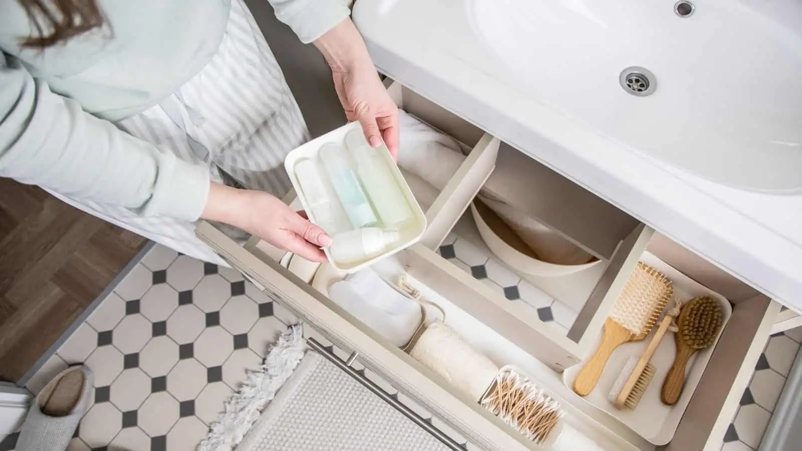 woman organizing bathroom drawer