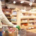 woman with cart in a grocery store