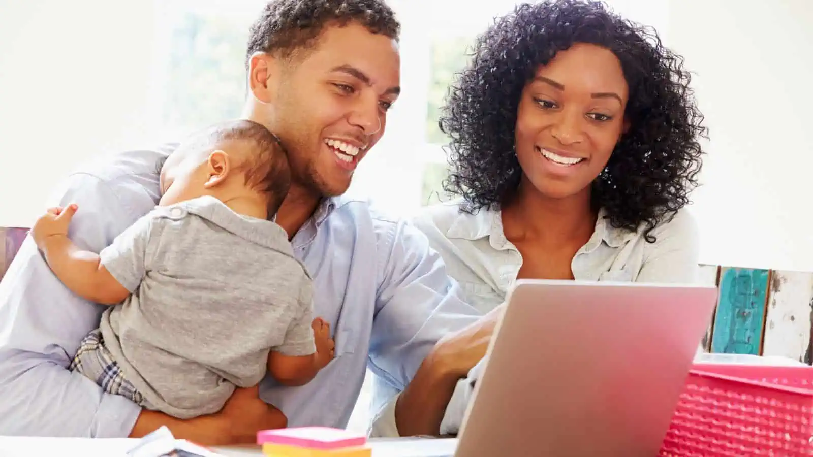 young family with baby working on computer