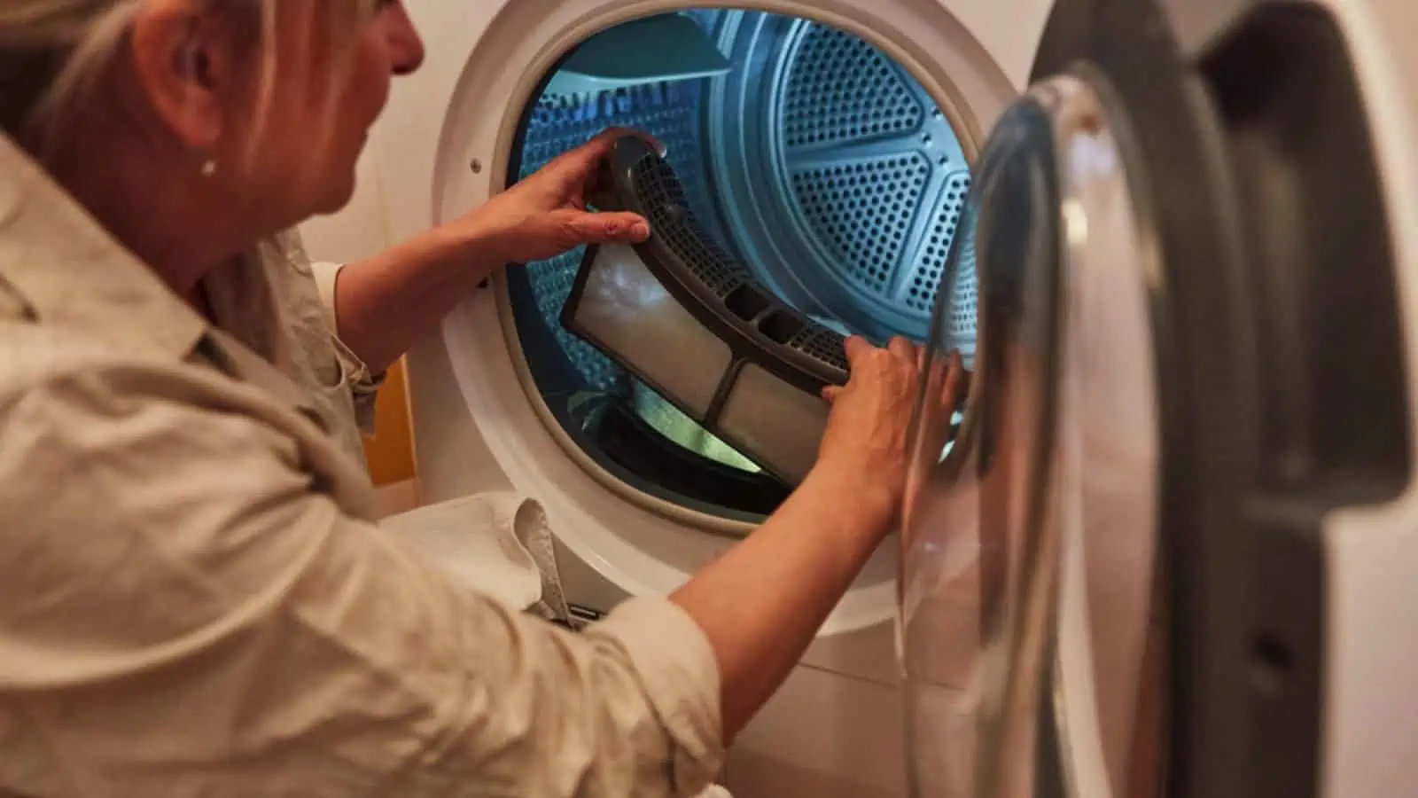 Woman cleans the lint filter