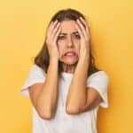 stressed woman yellow background