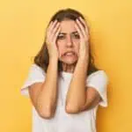 stressed woman yellow background