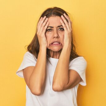 stressed woman yellow background