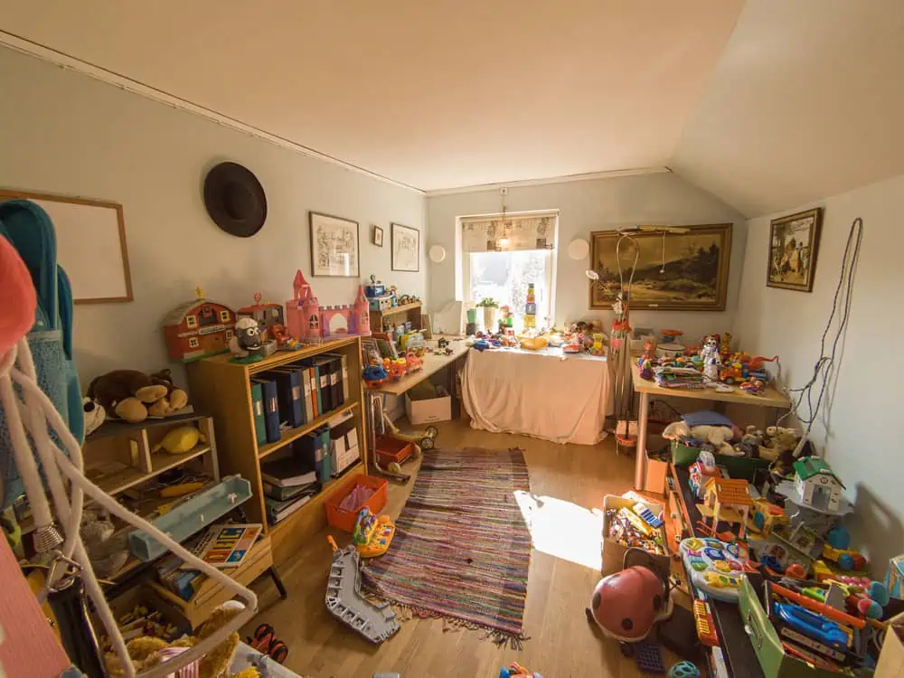 cluttered playroom with surfaces covered in toys