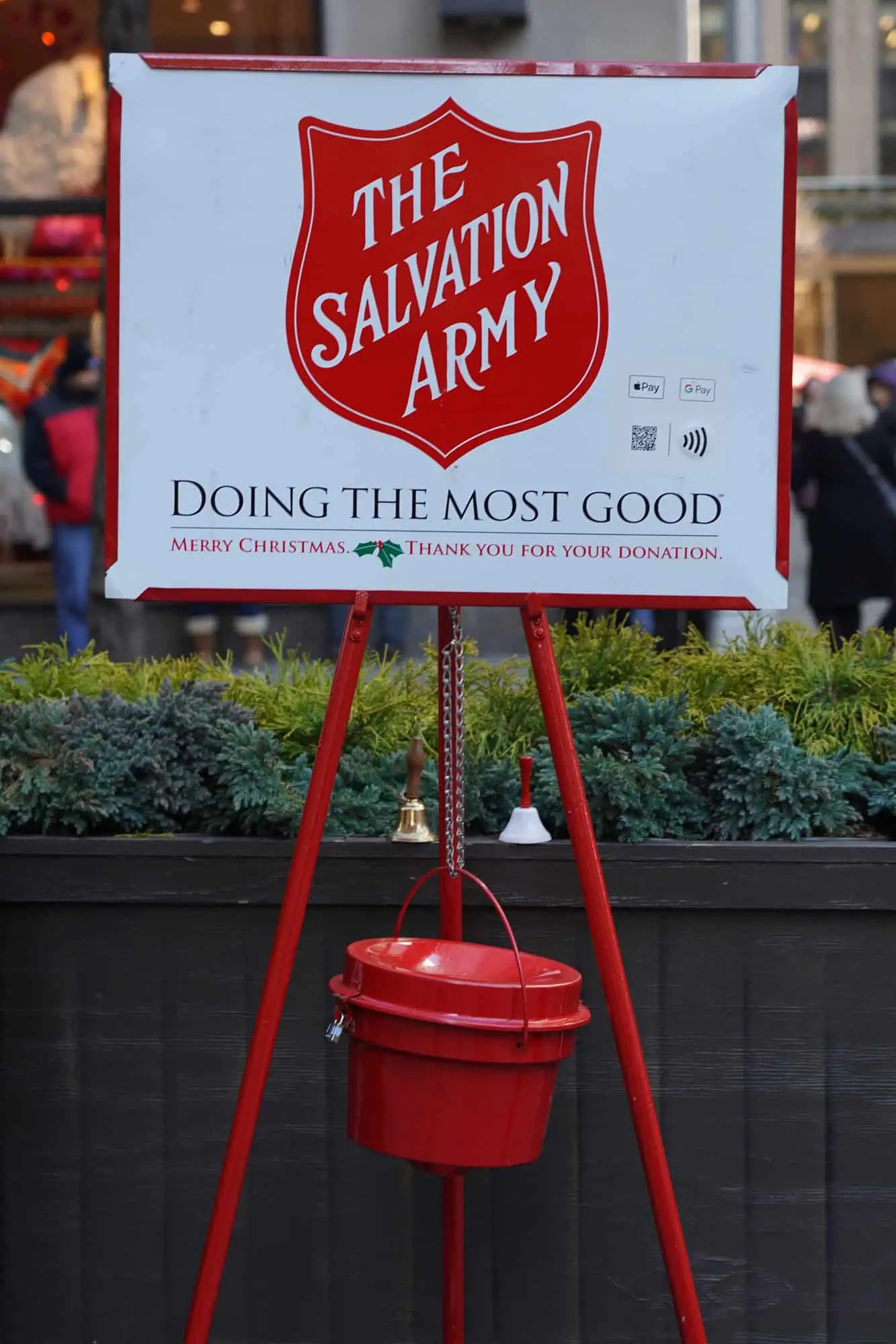 Salvation Army donation sign and red collection bucket